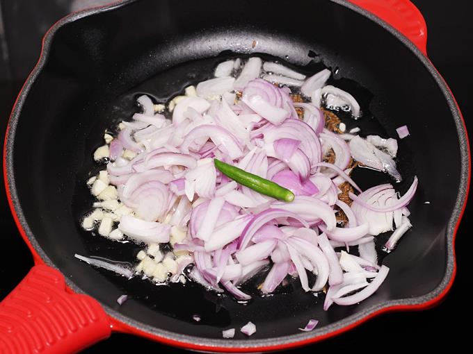 adding onions chilies to make bhindi ki sabji