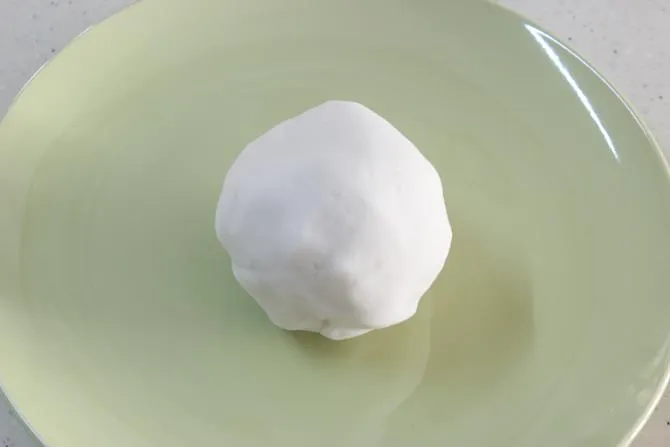 kneading rice flour dough to make kudumulu