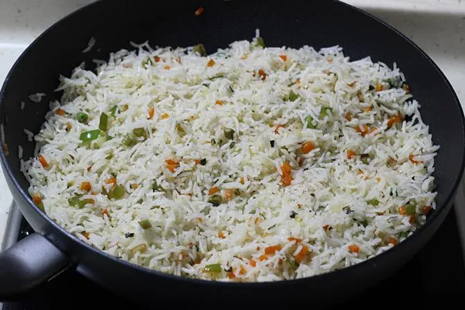 tossing vegetables to make veg fried rice