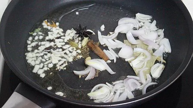 frying ginger garlic to make potato rice 