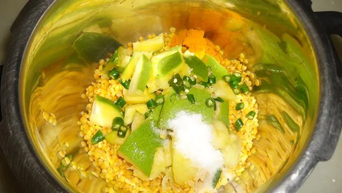 adding  chopped mango dal chilies salt