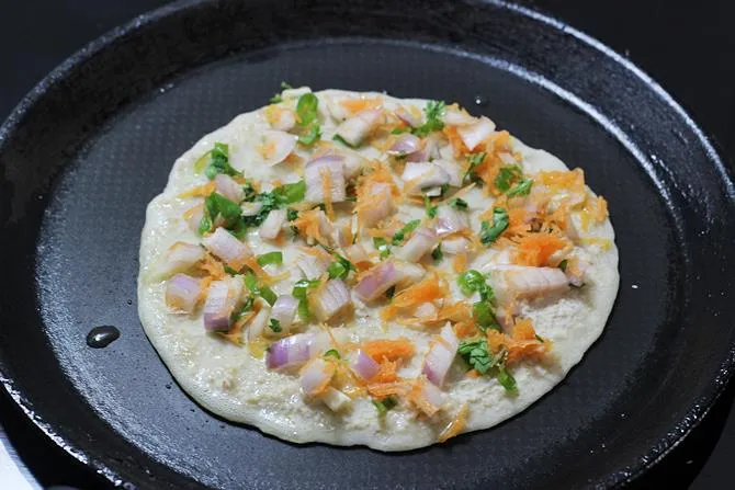 pouring batter on tawa for oats uttapam recipe