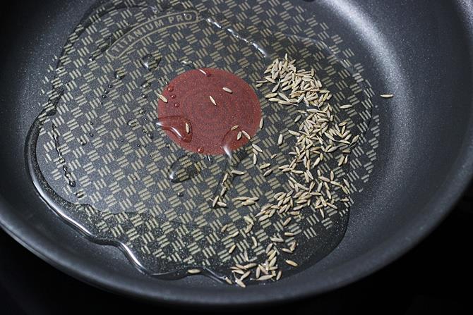 sauteing cumin to make chana paneer recipe