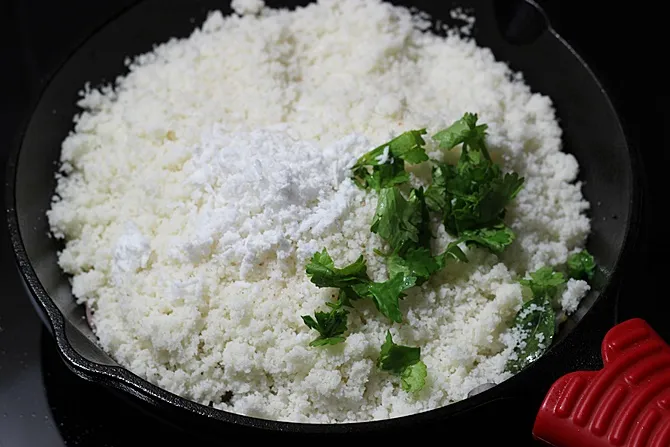 Add crumbled idli, coconut and coriander leaves