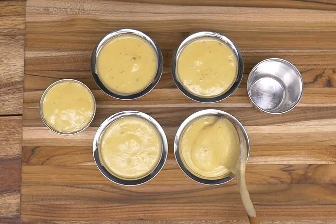 filling kulfi molds with mango mixture