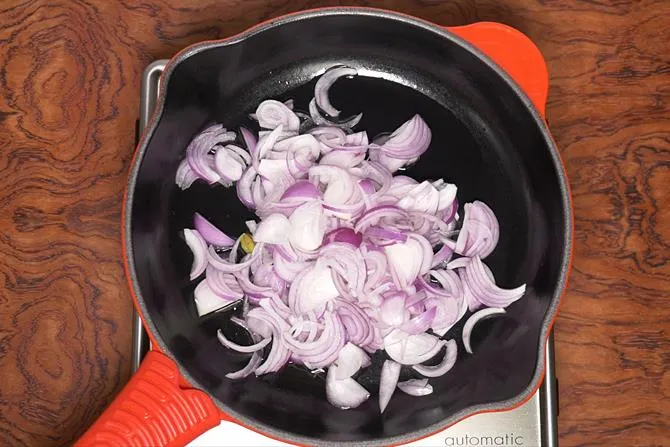 frying onions to make chicken korma