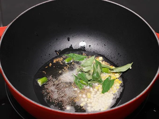 adding green chilies to make poori masala