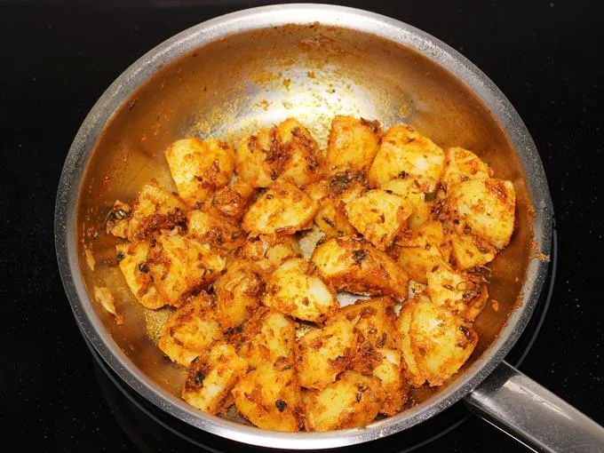 Frying potatoes to make jeera aloo