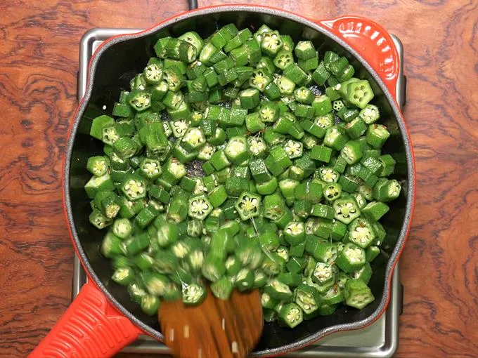 stir frying bhindi until the slime reduces