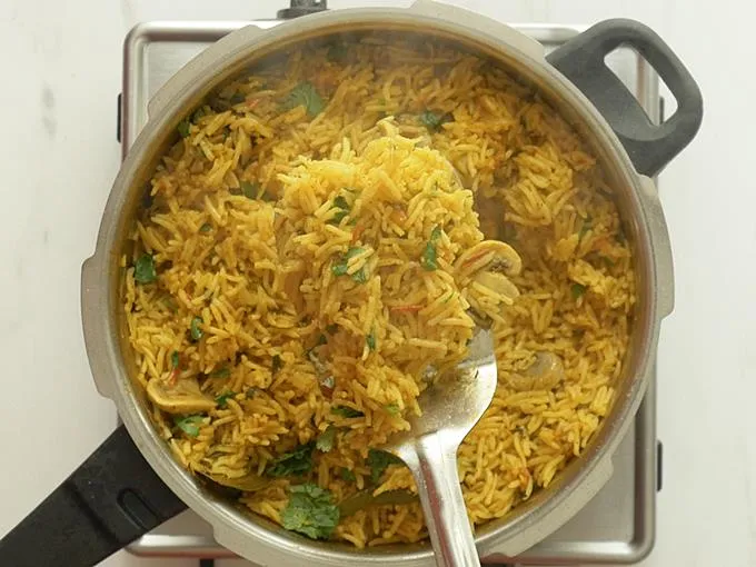 fluff up the mushroom biryani with a fork