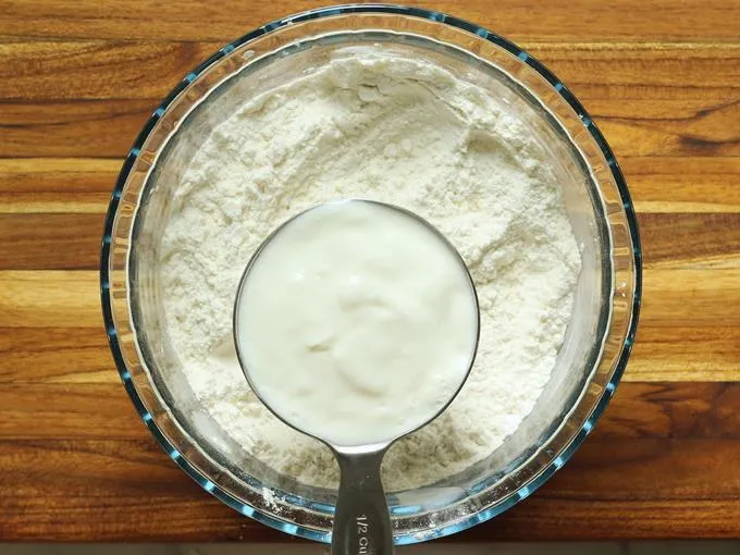 adding curd to make jalebi batter