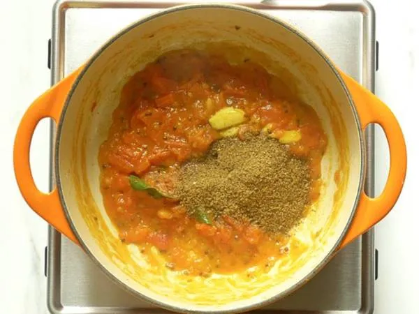 adding rasam powder to pot