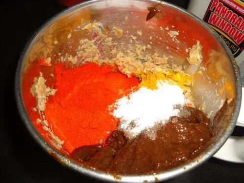 adding chilli powder turmeric salt