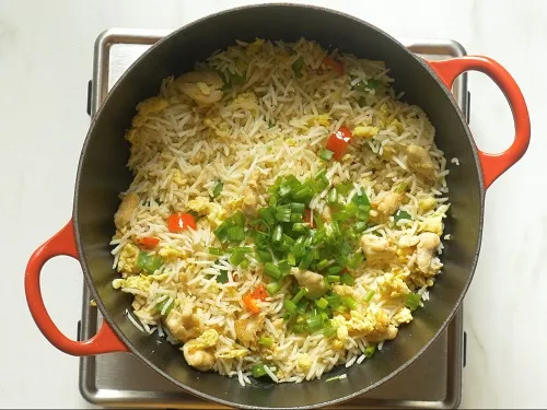 frying chicken fried rice with scallions