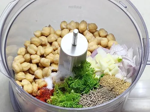 processing chickpeas herbs spices in a food processor