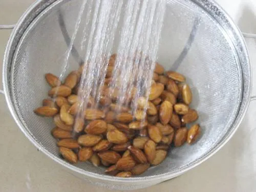 rinsing almonds for making barfi
