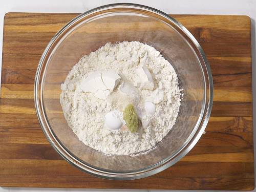 adding dry ingredients to make naan