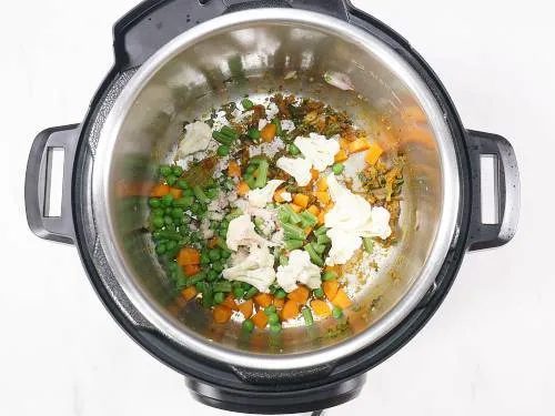 adding mint, spices and veggies to the pot