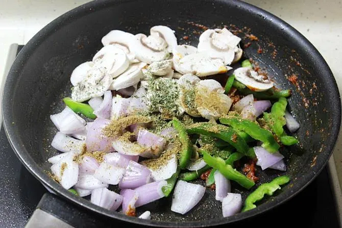 adding mushrooms bell peppers to pan