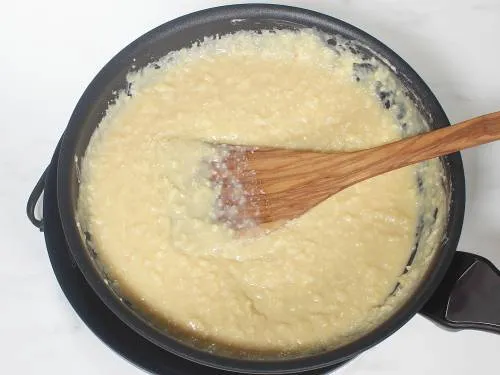thick kalakand mixture cooking in a pan