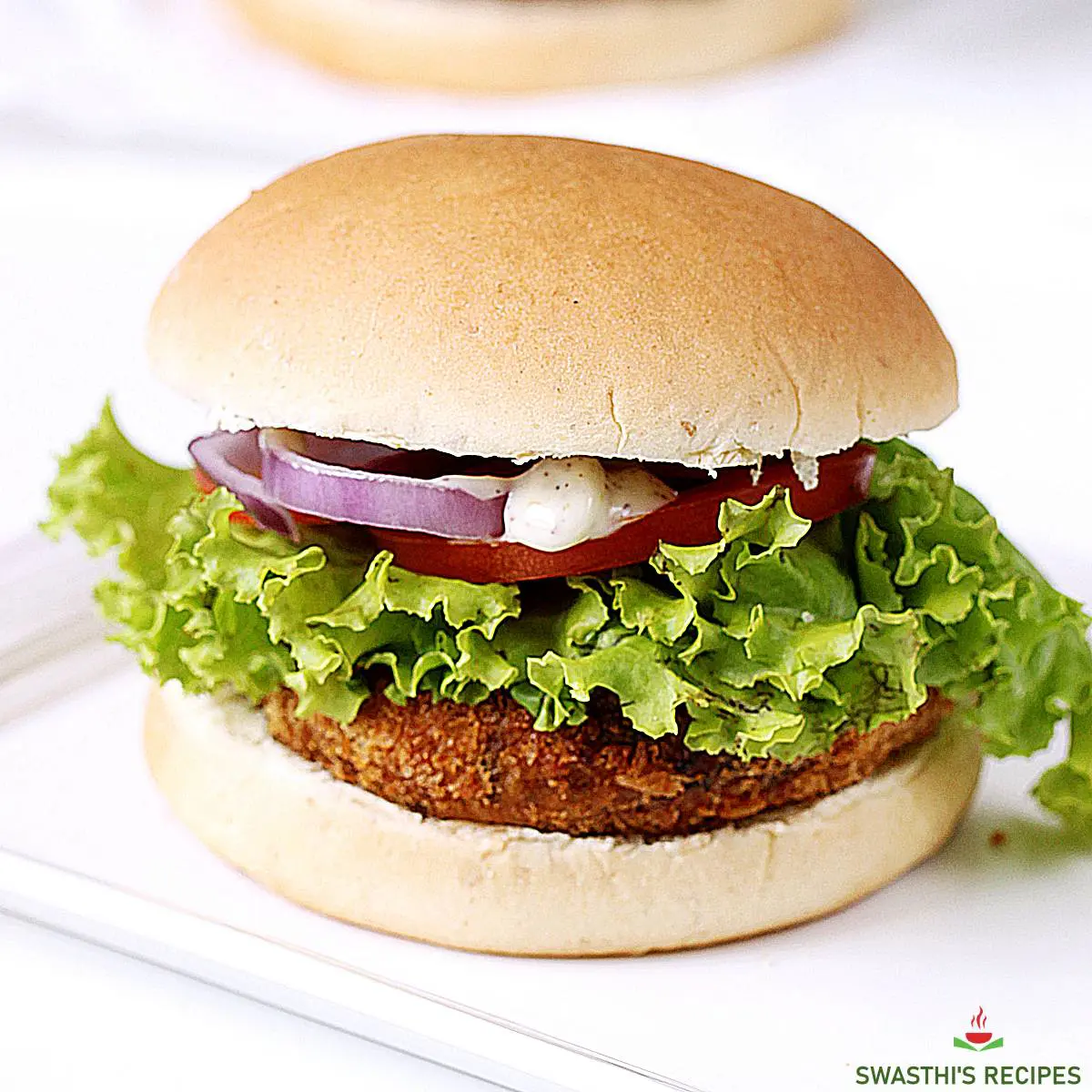 https://www.indianhealthyrecipes.com/wp-content/uploads/2021/01/veggie-burger-recipe-1.jpg.webp