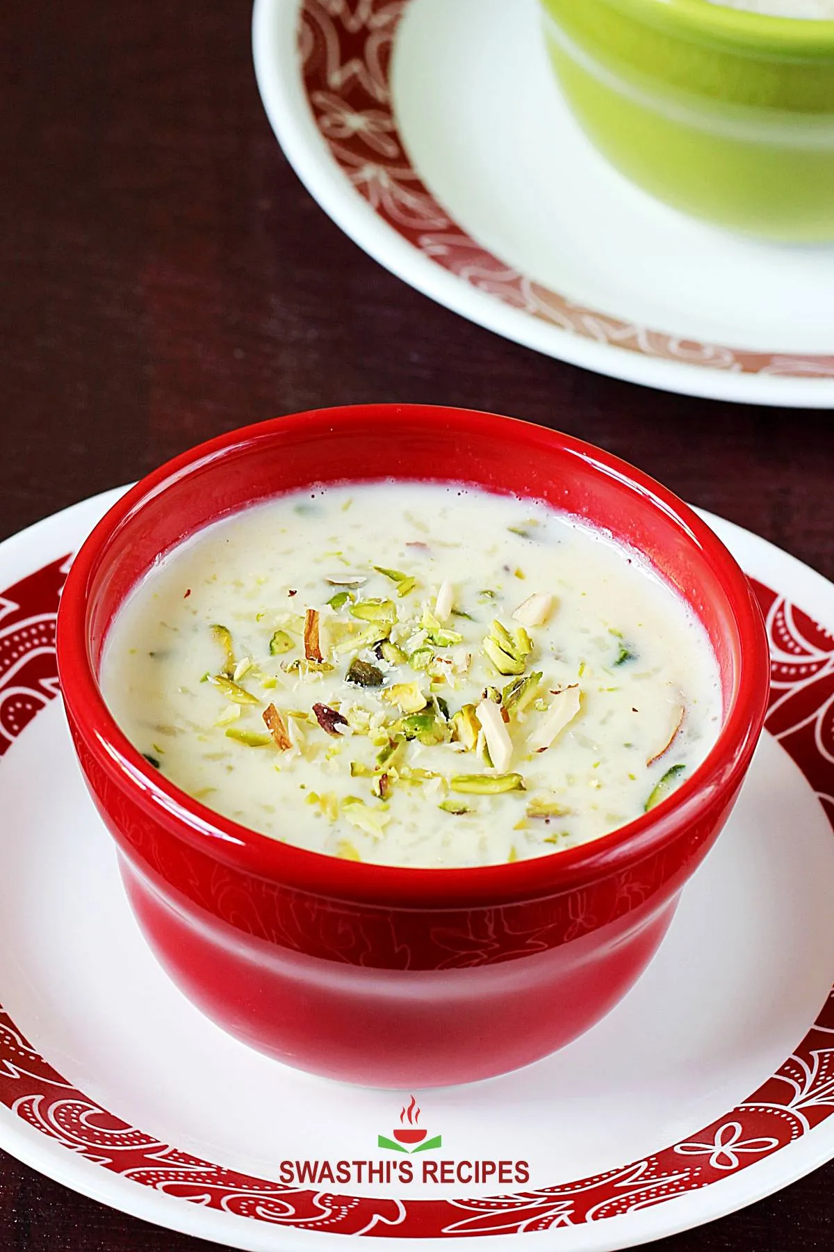 kheer recipe - rice kheer served in a bowl garnished with nuts