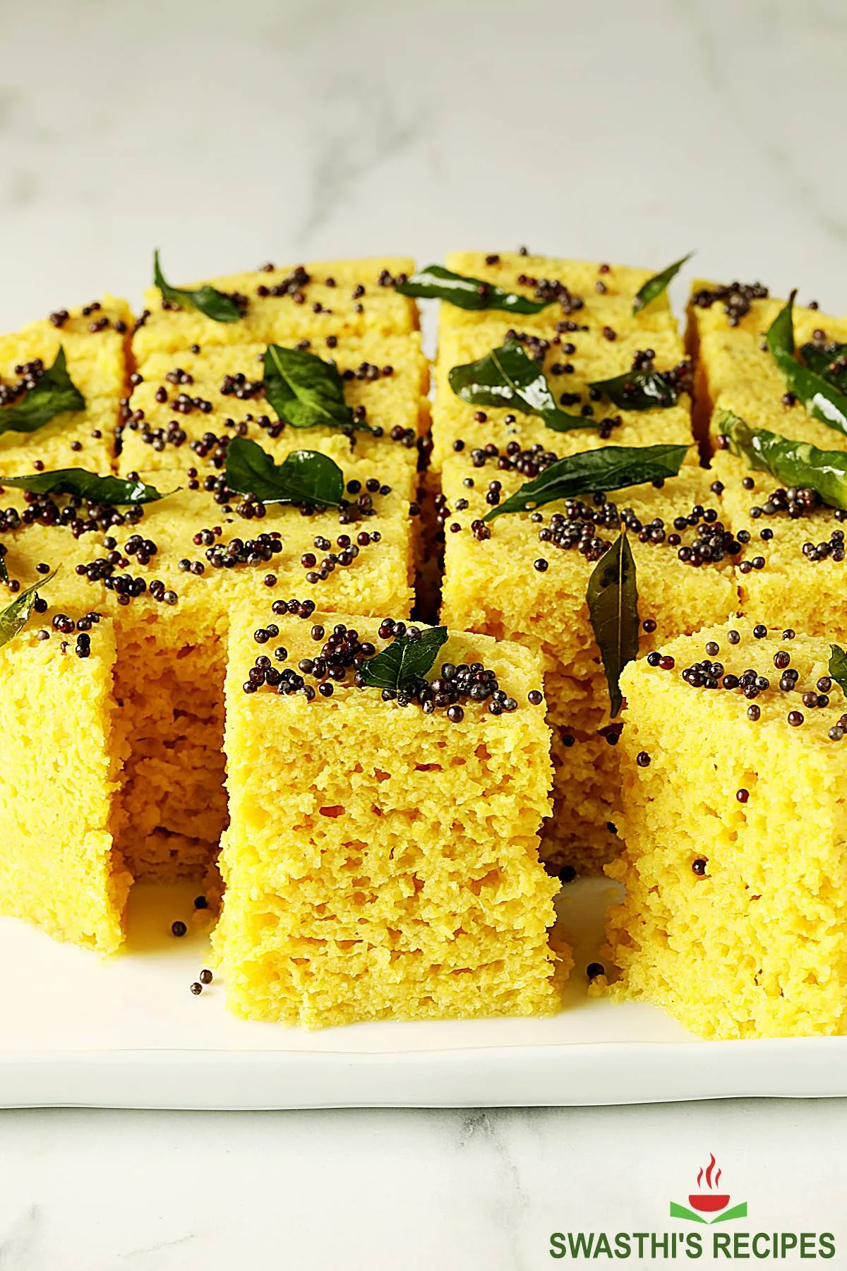 Dhokla also known as Khamn dhokla served in a white tray