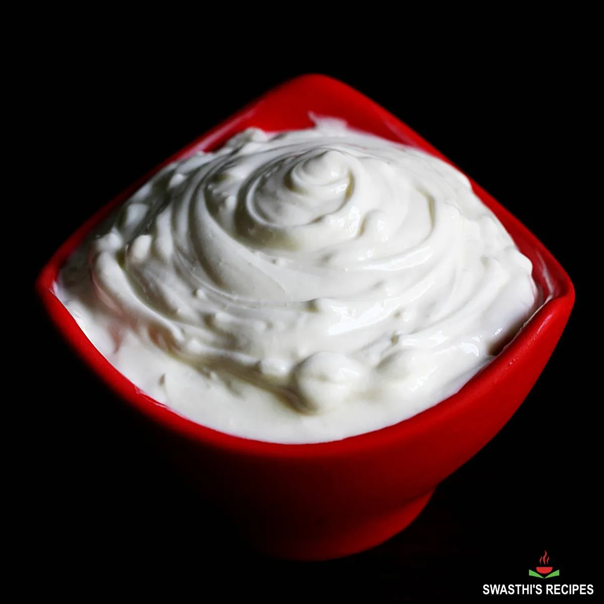 Hung curd served in a red bowl