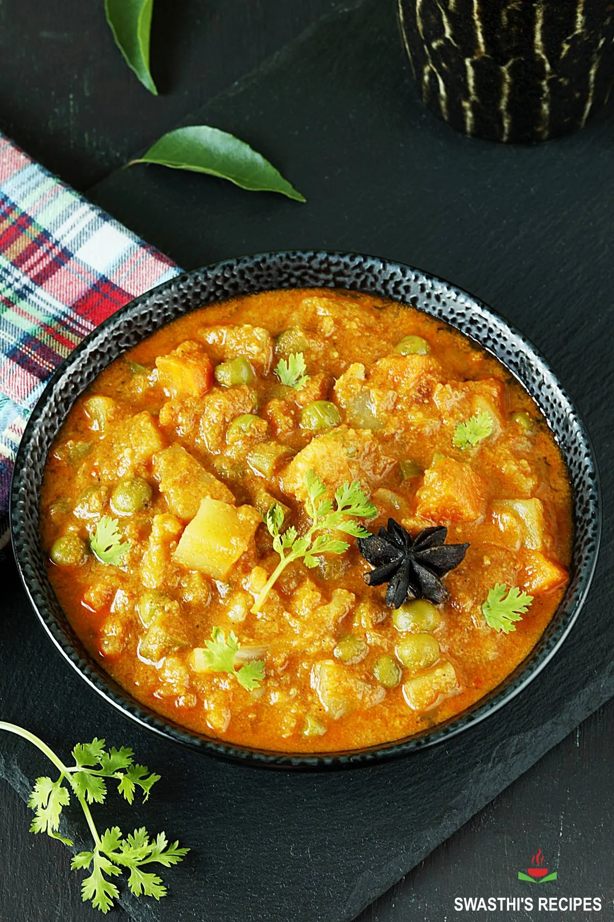 Veg kurma also known as vegetable korma served in a black bowl