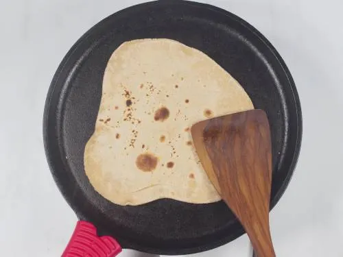 cooking layered chapati on a tawa