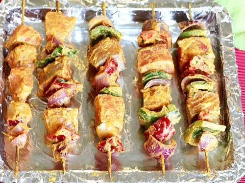 prepared tandoori fish tikka skewers on a tray