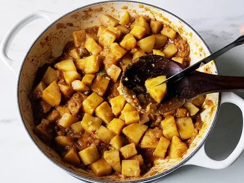 cut the cooked potatoes for saag