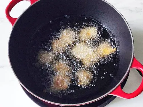 frying fish pakora in a kadai