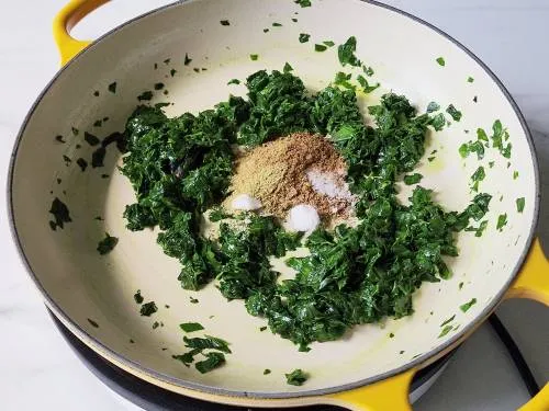 adding spices to methi