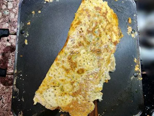 instant jowar dosa in a pan