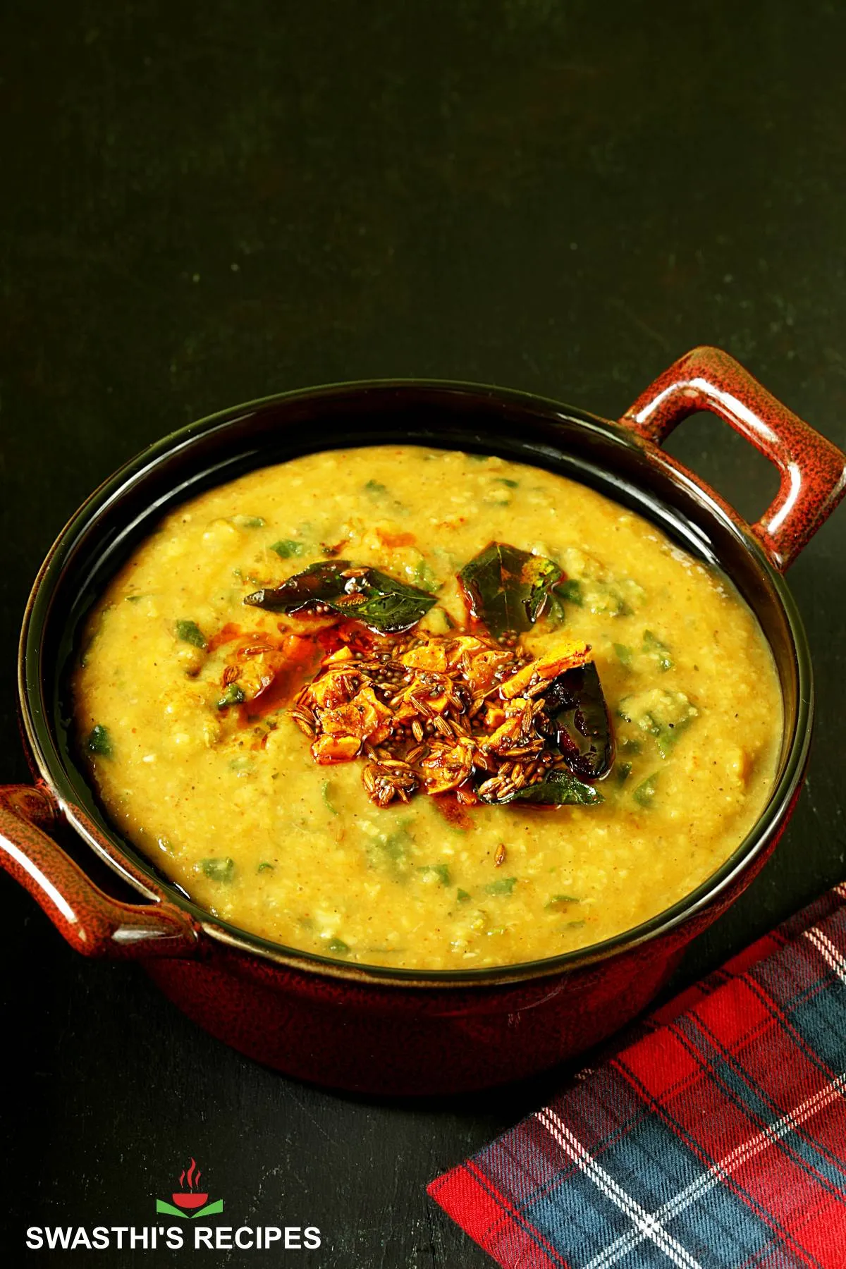 Dal Palak served in a brown bowl