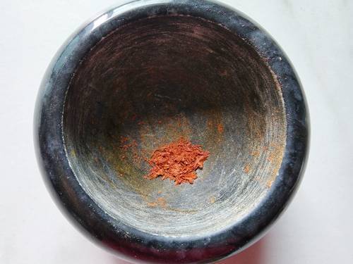 crushed saffron in a stone mortar